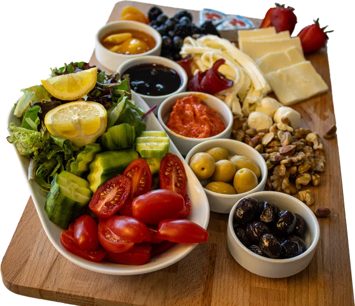Turkish breakfast board with cheeses, olives, jams, salad and nuts