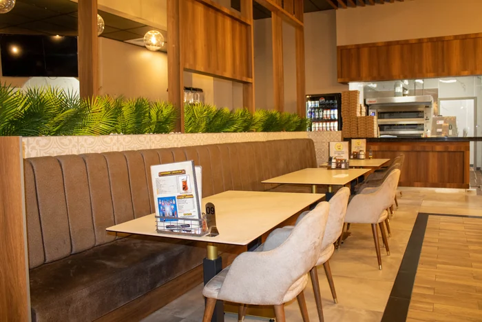 Seating beside the bakery counter and oven